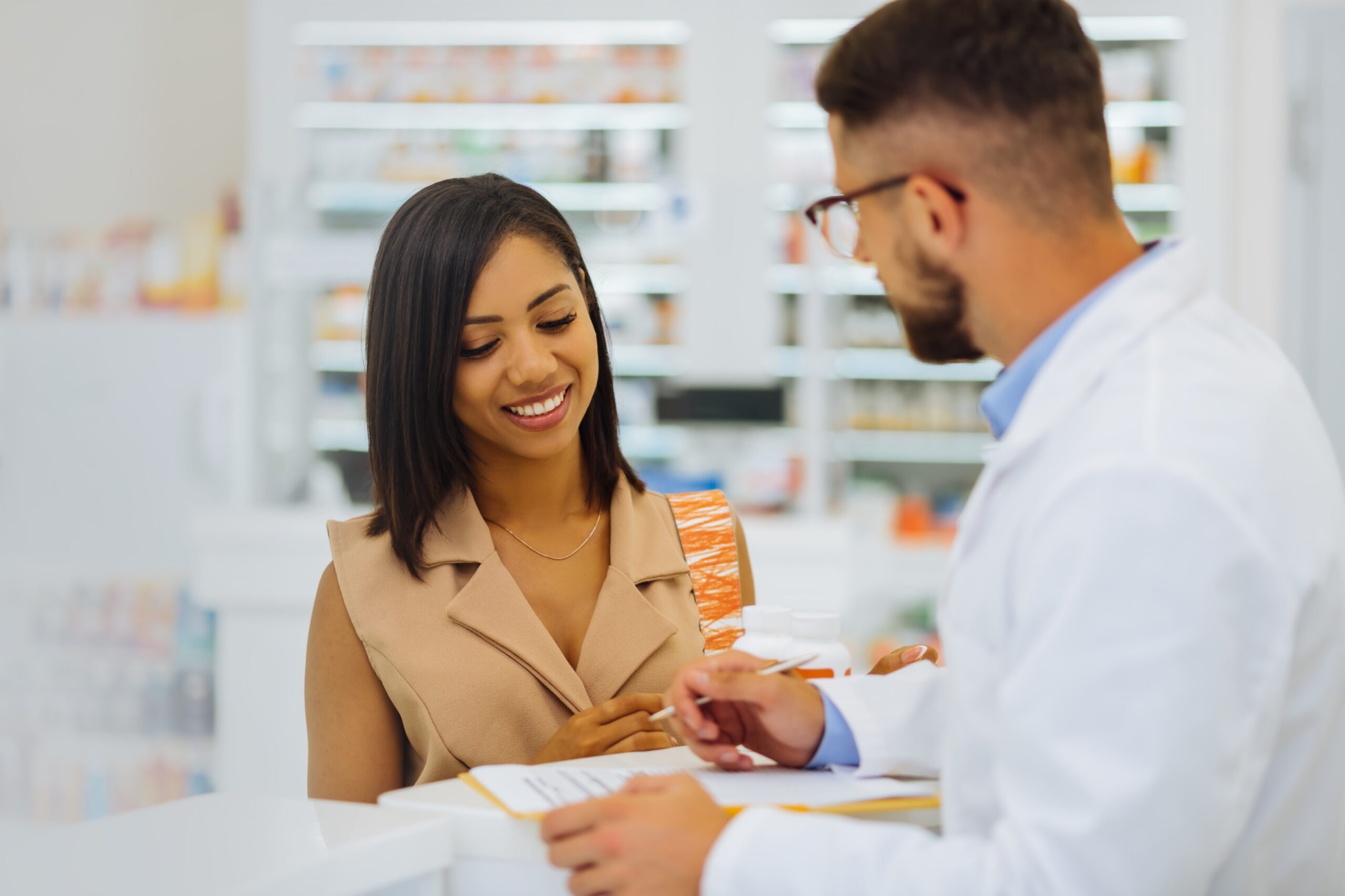 Patient smiling and conversing with pharmacist