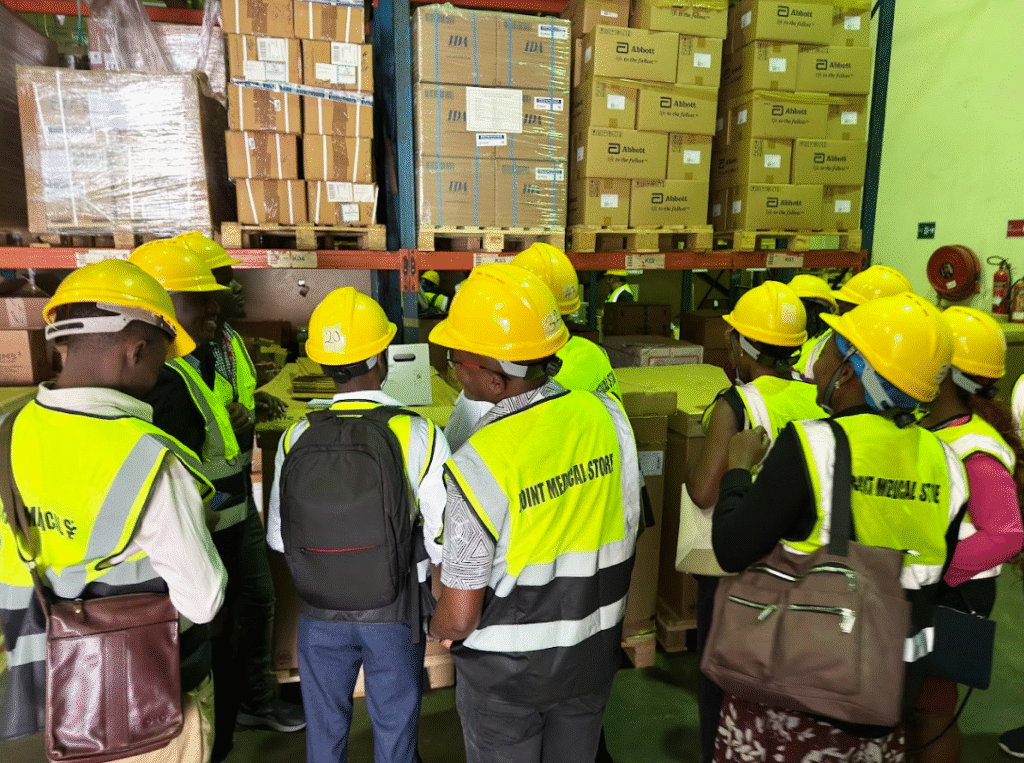 Pharmacy professionals touring a warehouse.